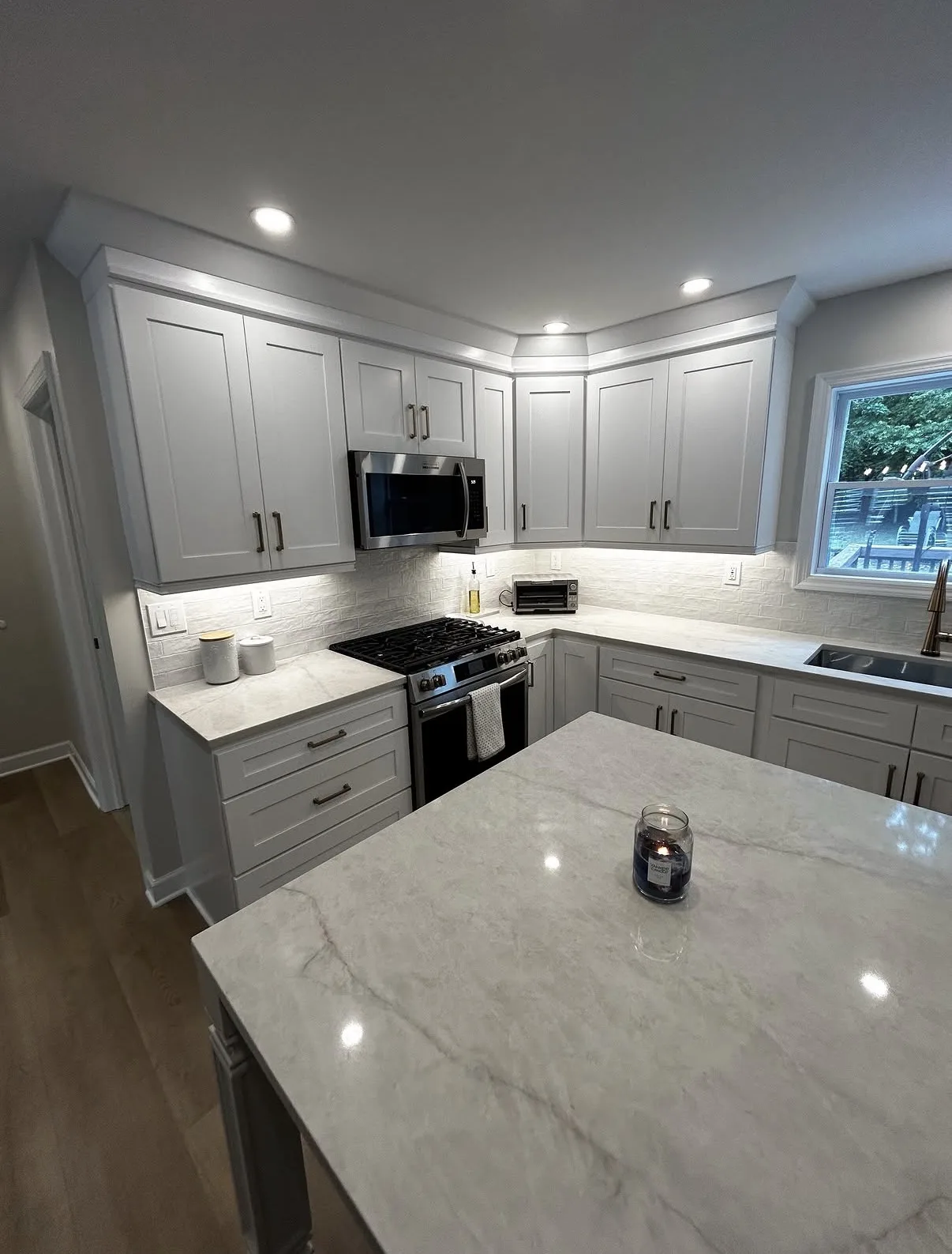 Renovated kitchen cabinetry countertops and lighting