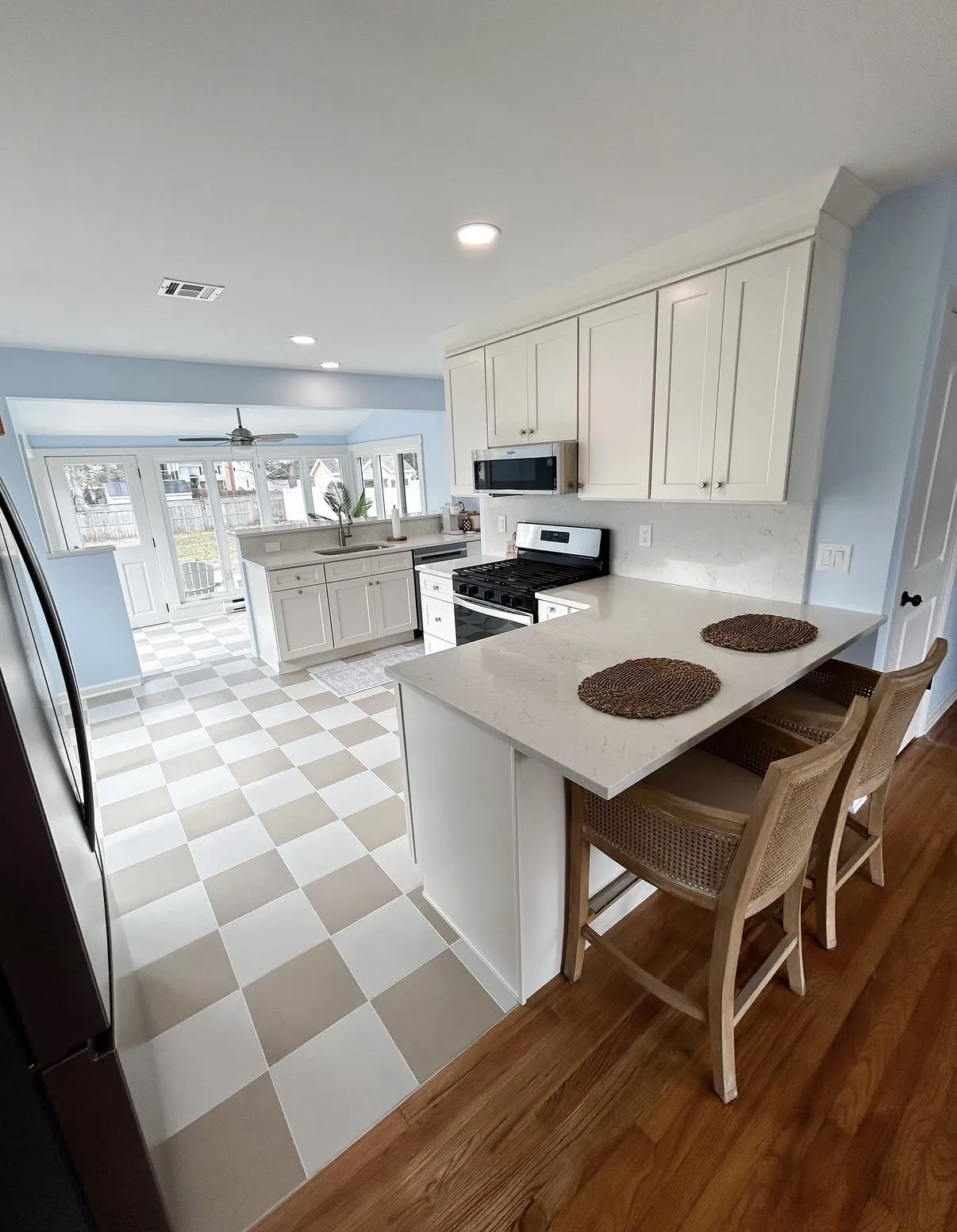 Kitchen layout featuring coordinated cabinetry and island